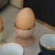 Four coloured egg cups with a golden rim from the 50s.