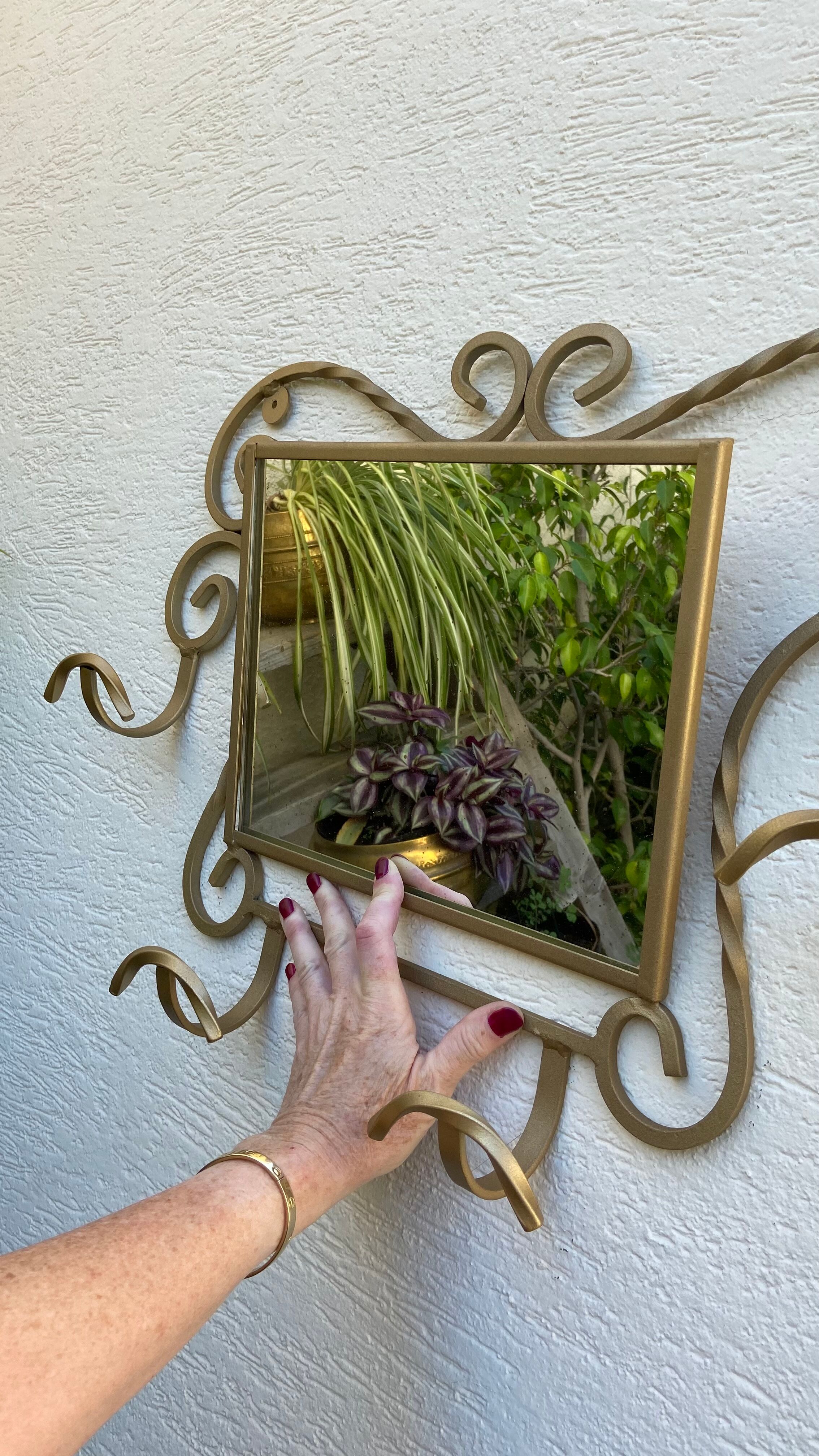 Wall-mounted gilded wrought iron coat rack with mirror