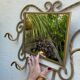 Wall-mounted gilded wrought iron coat rack with mirror