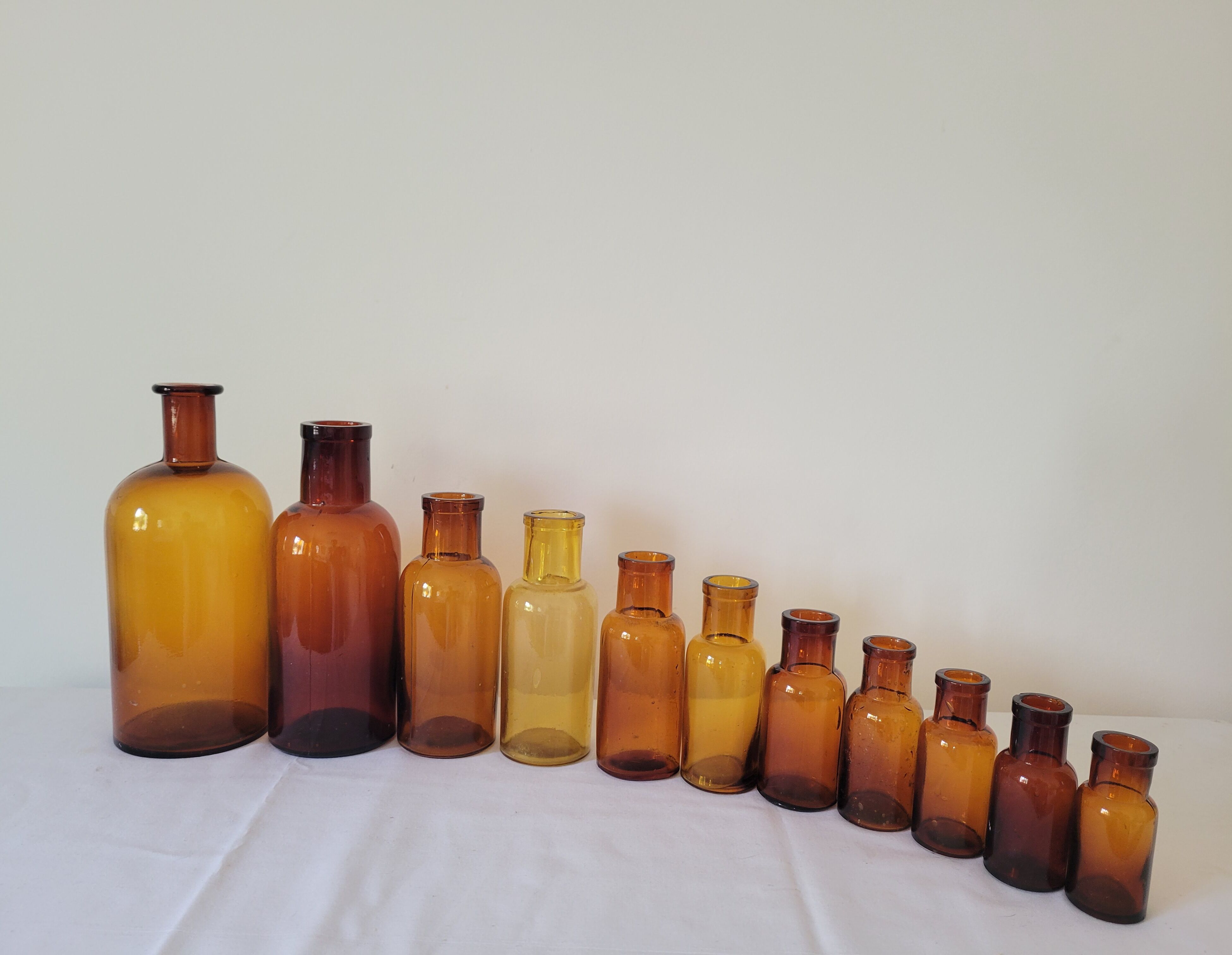11 bottles of amber glass apothecary
