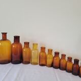 11 bottles of amber glass apothecary