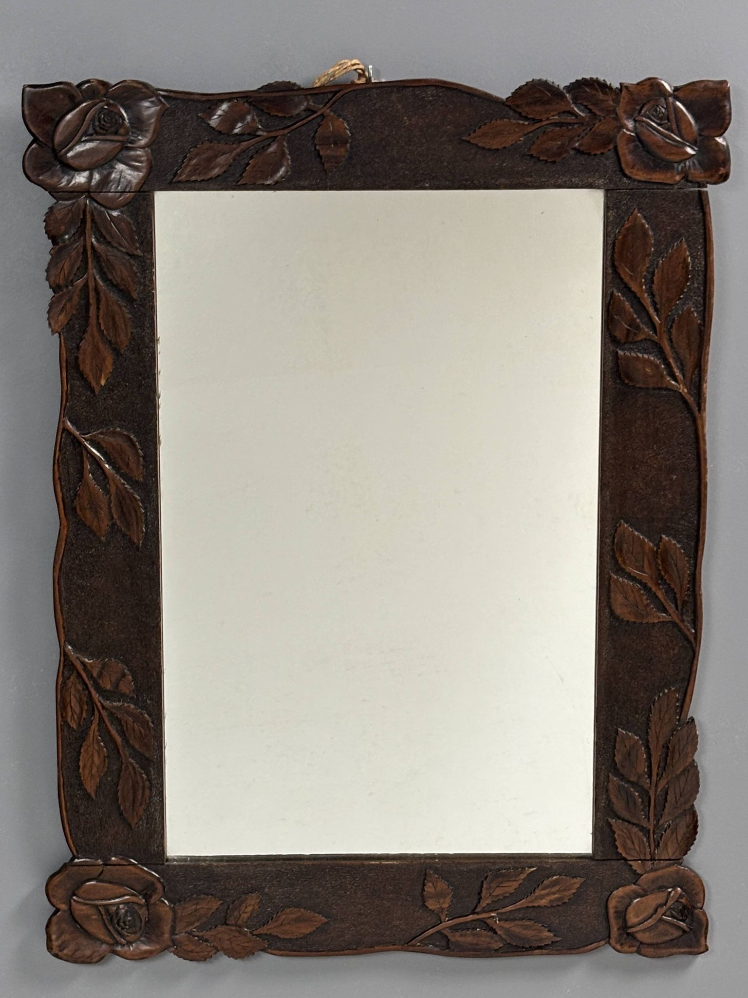 Arts & Crafts hand-carved wall mirror with floral roses, early 20th century
