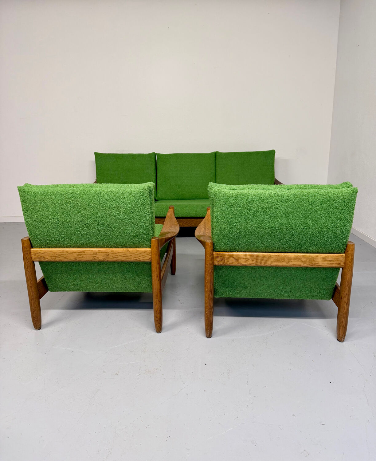 Living room sofa and Scandinavian design armchairs from the 1960s in green boucle.