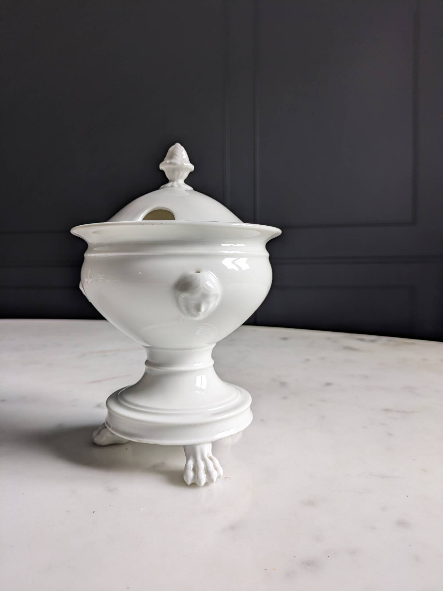White porcelain confiturier with lion paws and masks. 19th century.