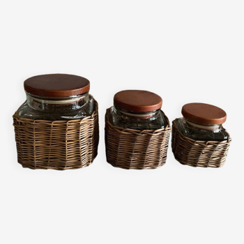 Set of three glass and woven wicker jars