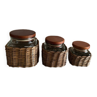 Set of three glass and woven wicker jars
