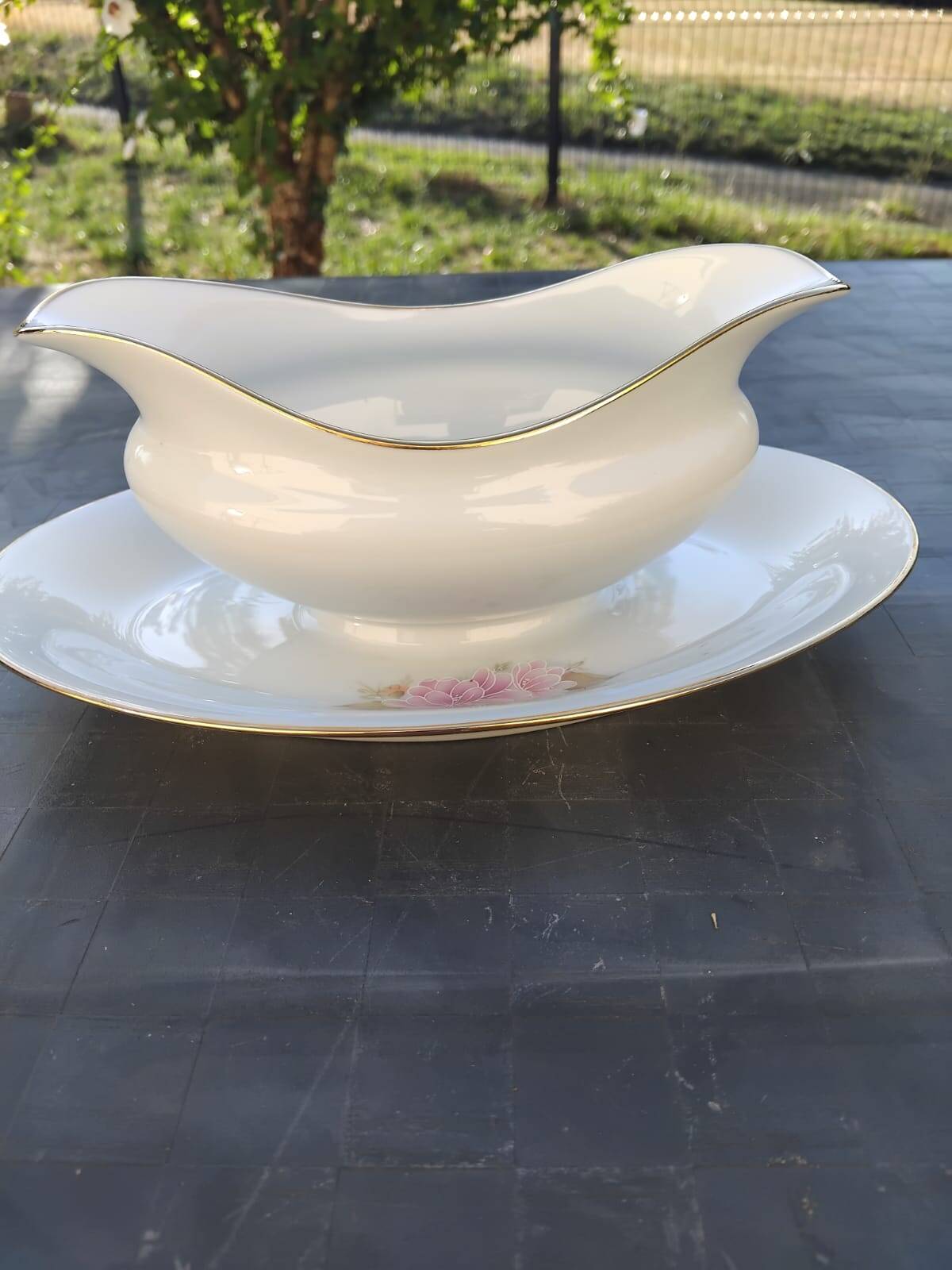 Vintage fine porcelain sauce boat with gold gilding.
