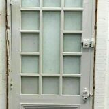 Service door with small tiles and 20th century glass impost