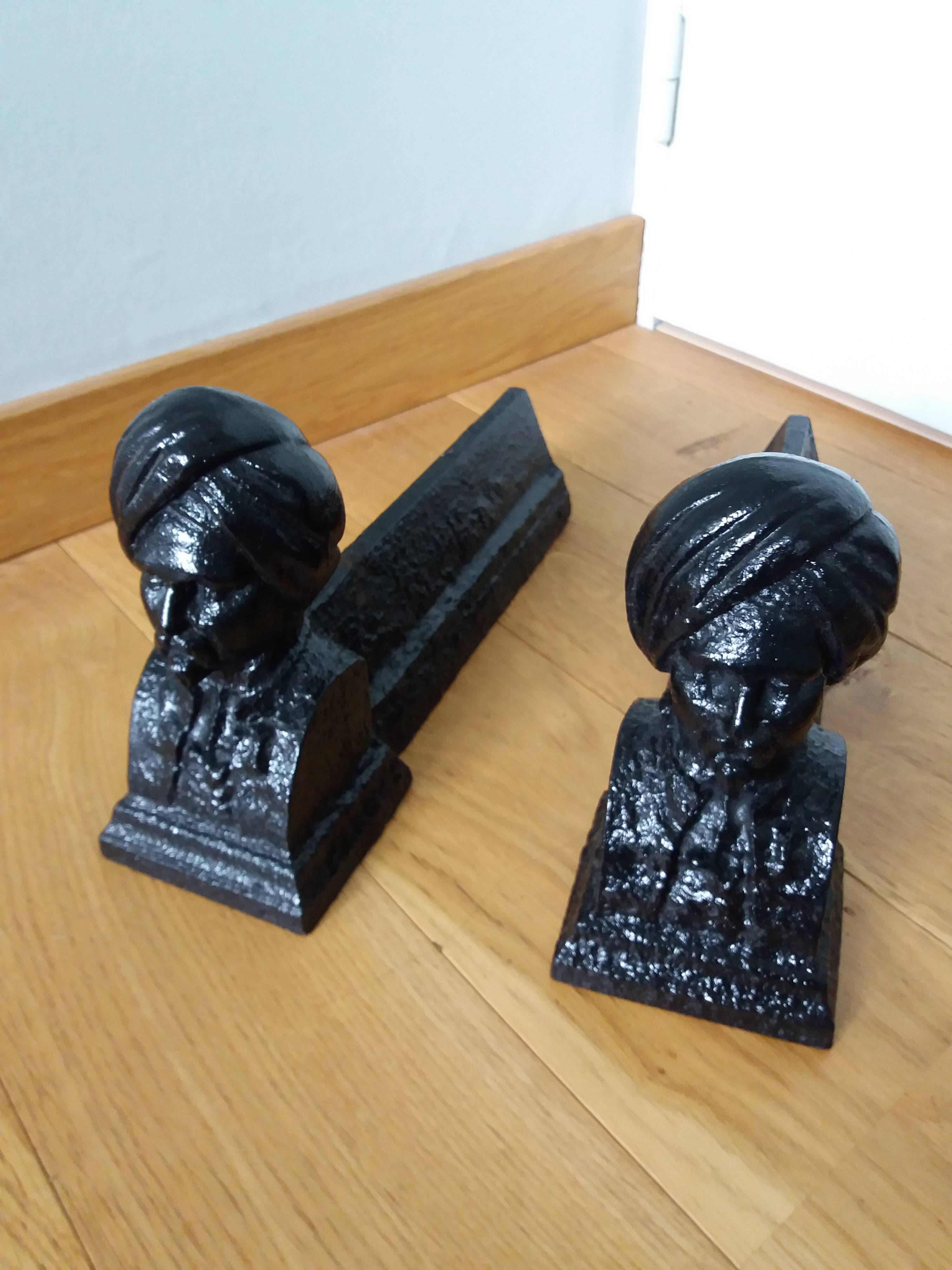 Cast iron andirons with character heads