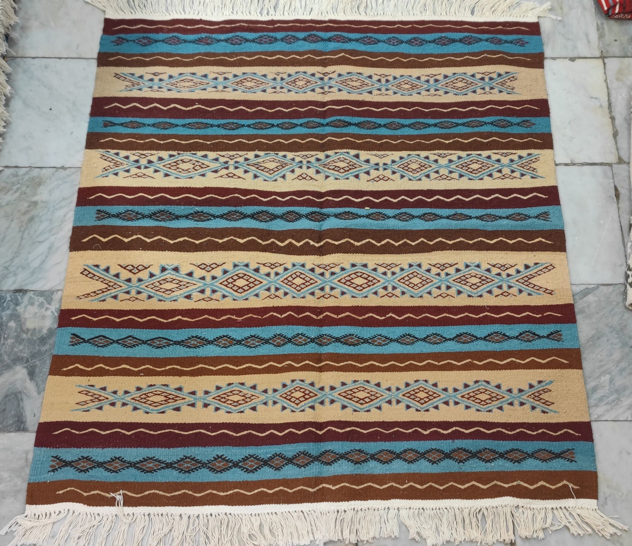 Multicolored hand-woven Berber rugs in natural wool