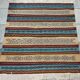Multicolored hand-woven Berber rugs in natural wool