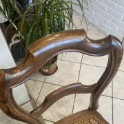 Pair of antique caned and wooden chairs from the 1900s.