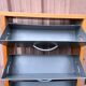 Scandinavian shoe storage cabinet in grey wood and metal.