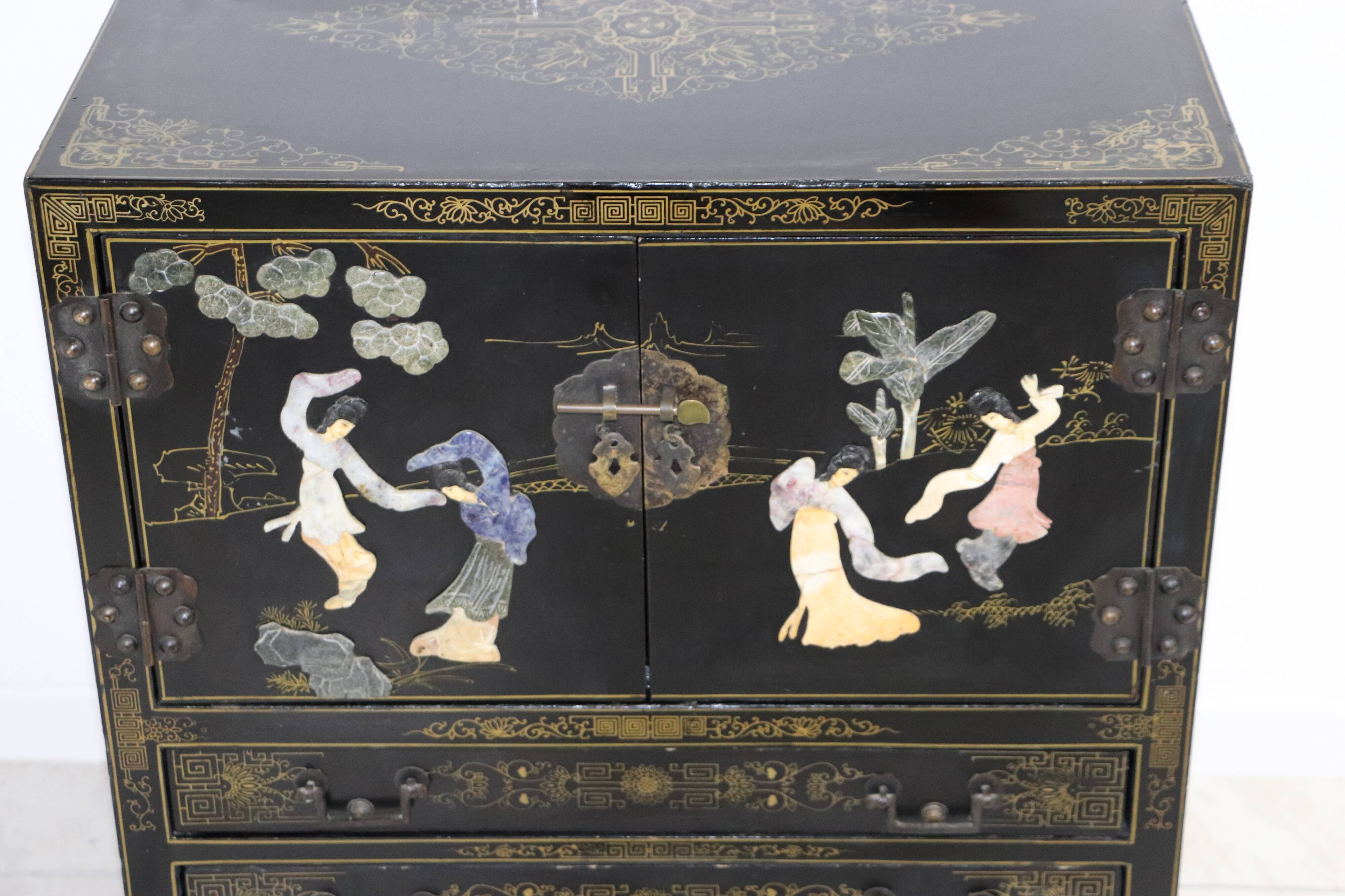 Black lacquered Chinese buffet with stone and ivory figures