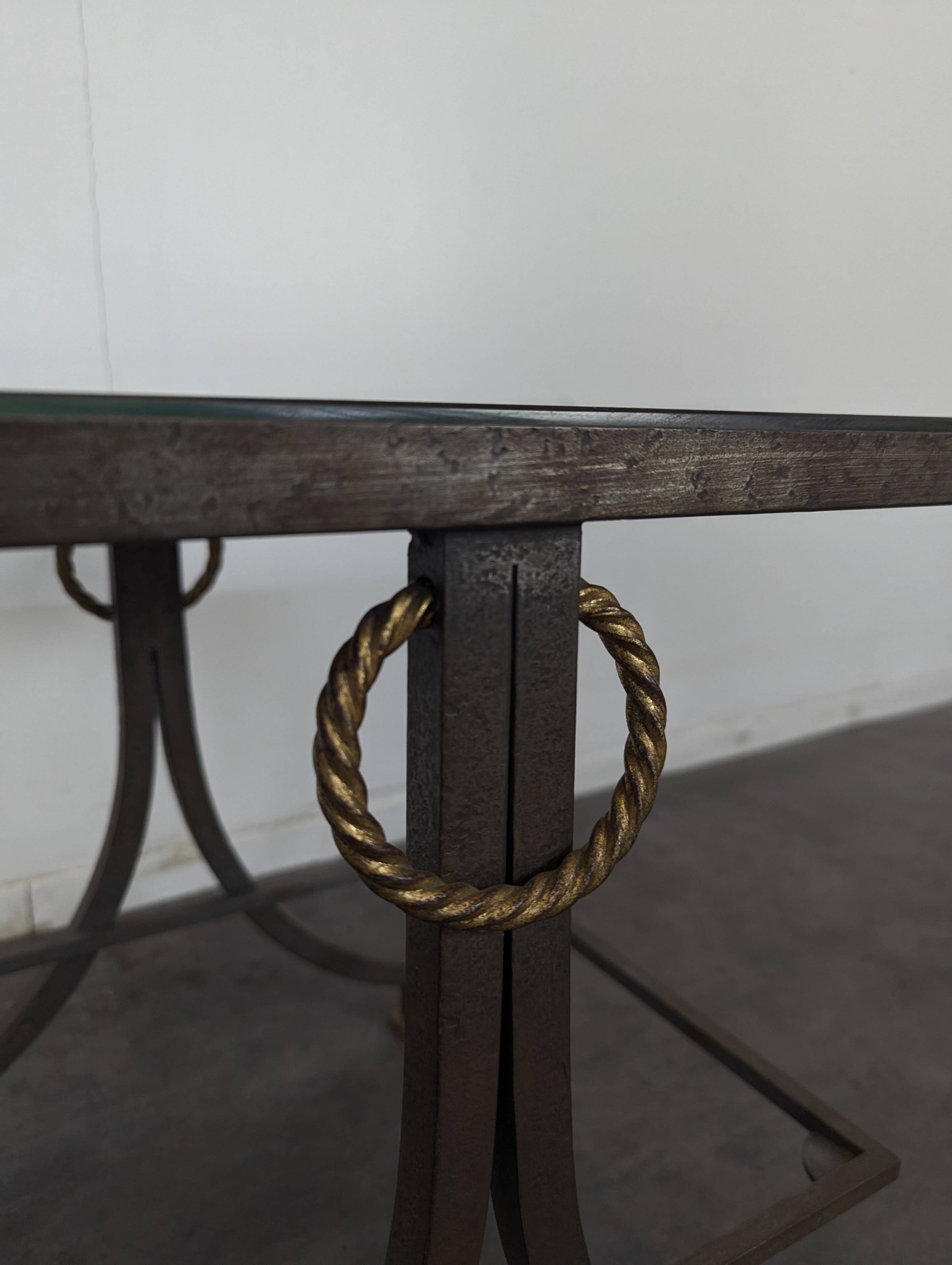 Neoclassical side table in wrought iron and eglomisé glass.