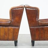 Set of 2 sheep leather wingback chairs with red corduroy seat cushions