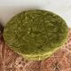 Green velvet storage pouffe from the 1960s.
