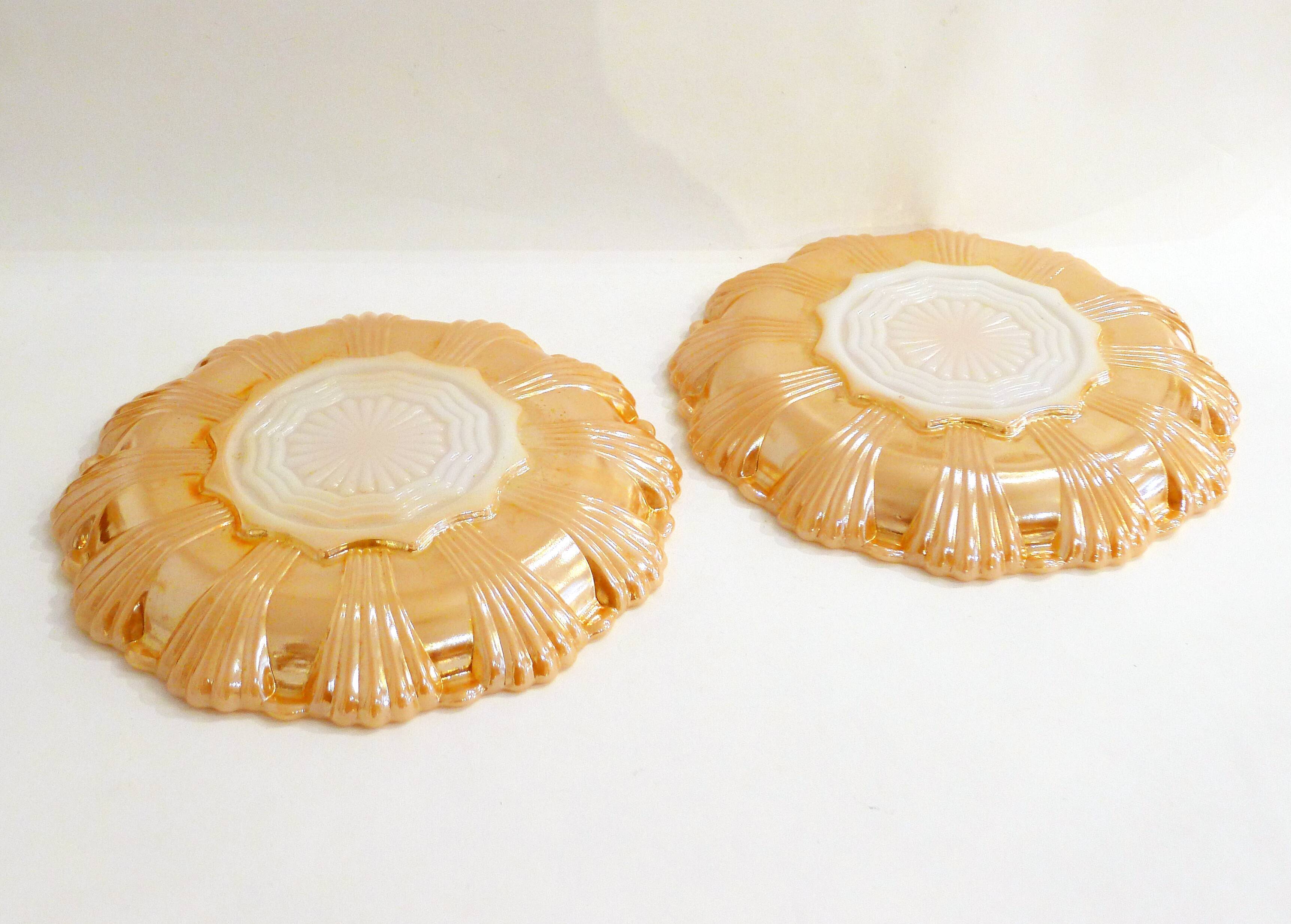 Pair of iridescent orange glass egg plates
