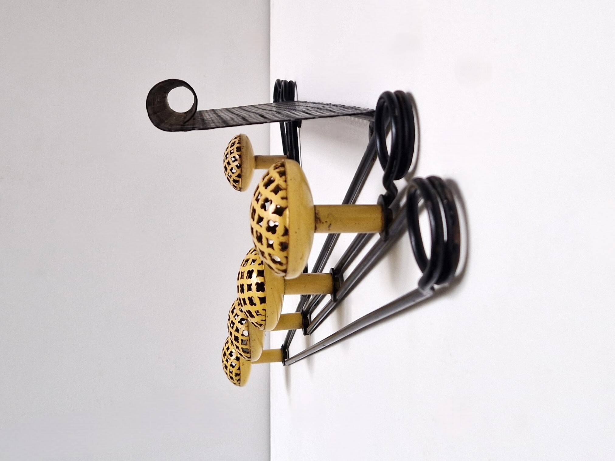 Black and yellow wall coat rack, France