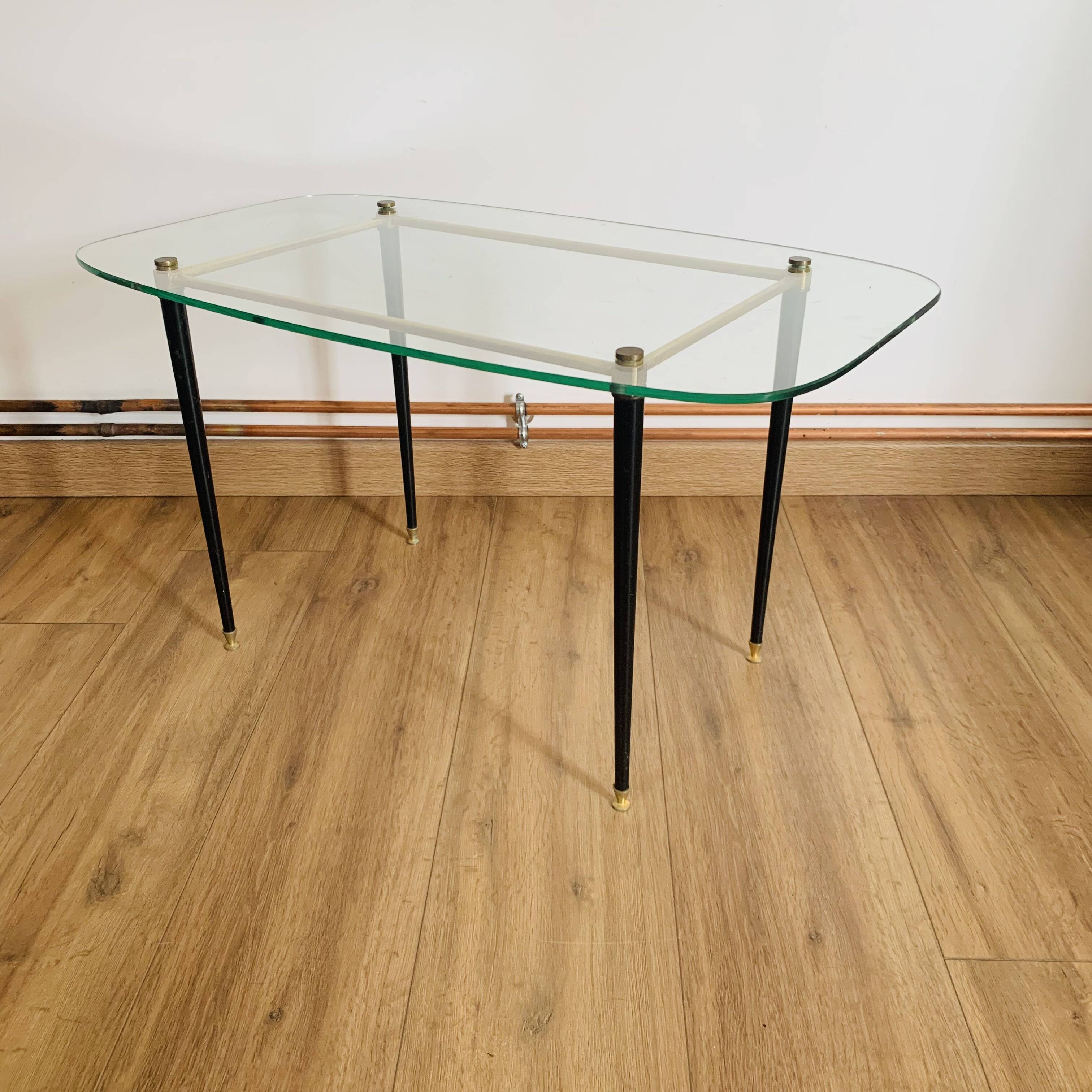 Coffee table from the 50s/60s, glass, brass, black metal.