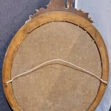 Golden oval mirror
