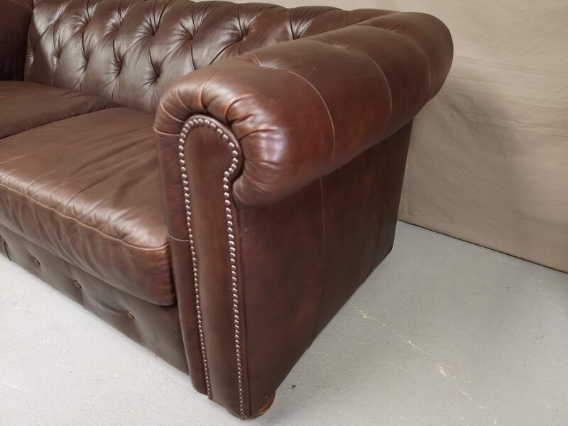 Three seater brown leather chesterfield sofa