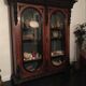 Large display cabinet in walnut veneer and blackened wood, 19th century.