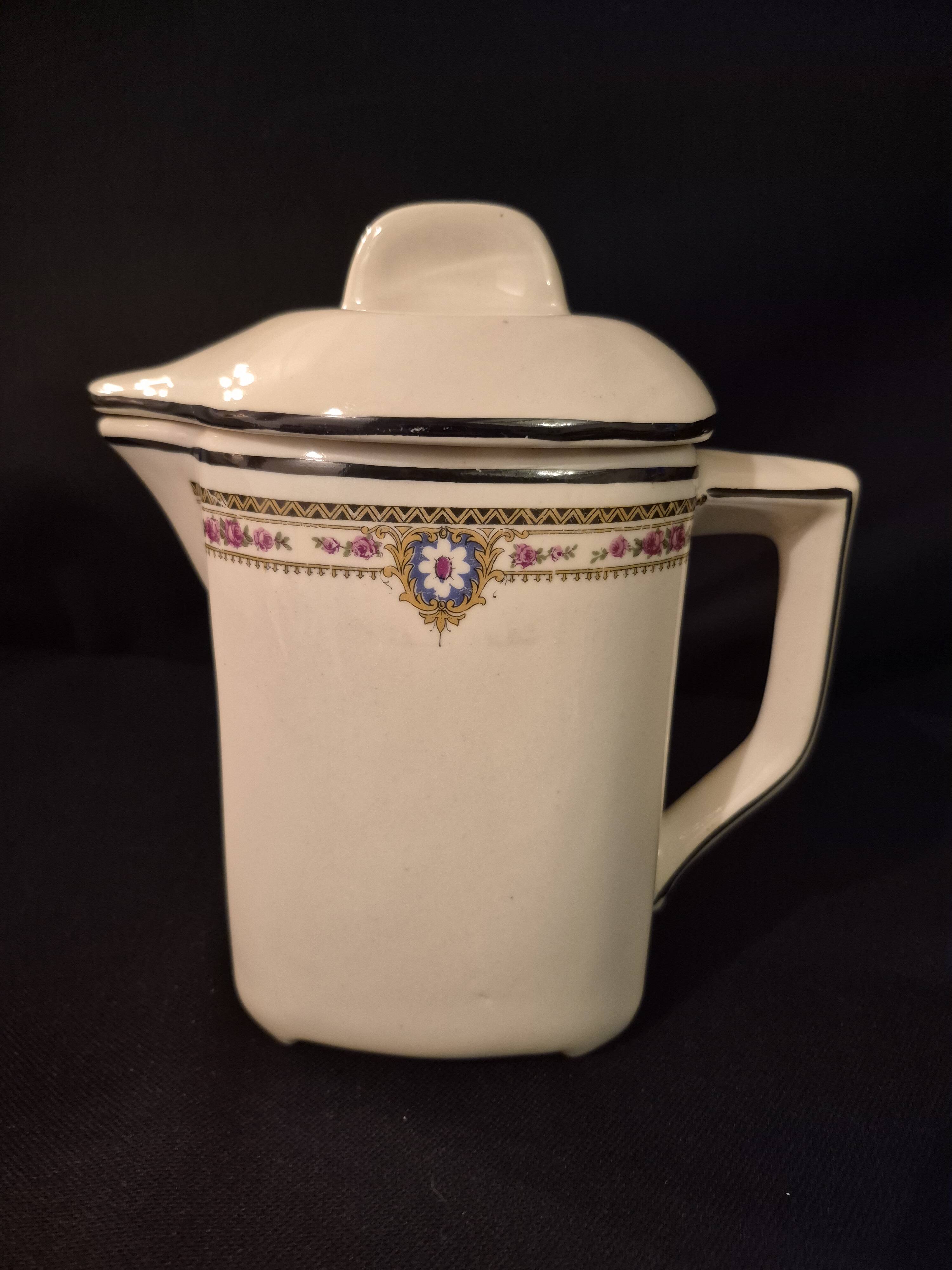 Old covered jug, vintage, geometric frieze with flowers and black trim.