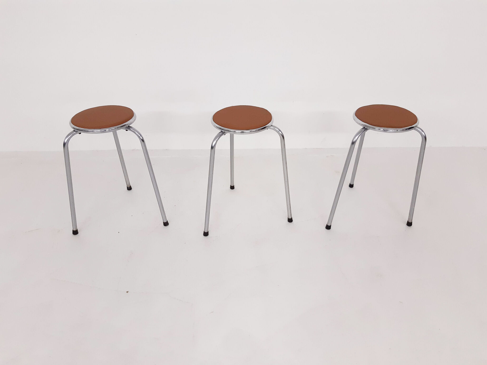 Set of 3 chrome stools with cognac leather seating, 1960's