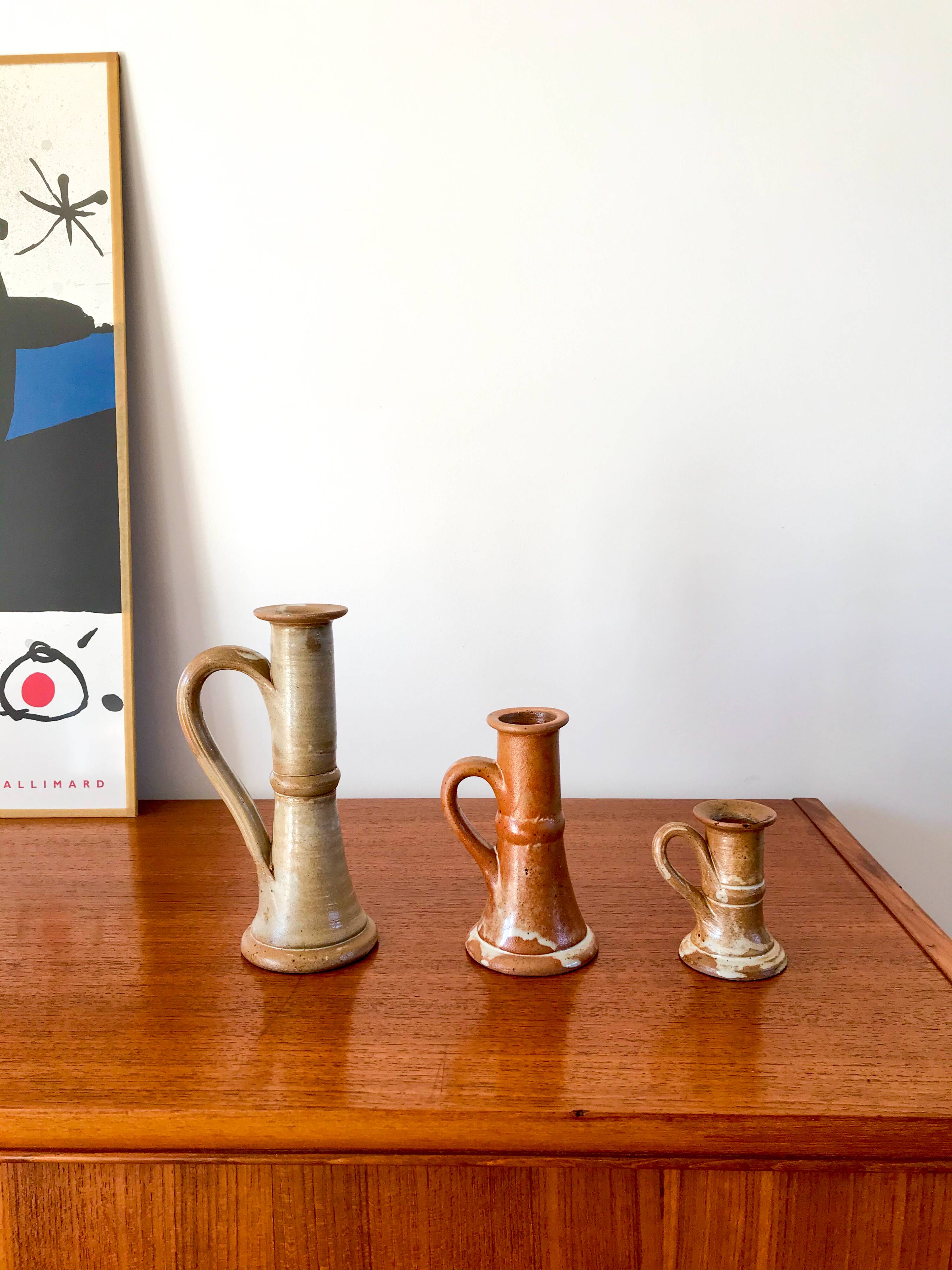 trio of 70s sandstone candlesticks