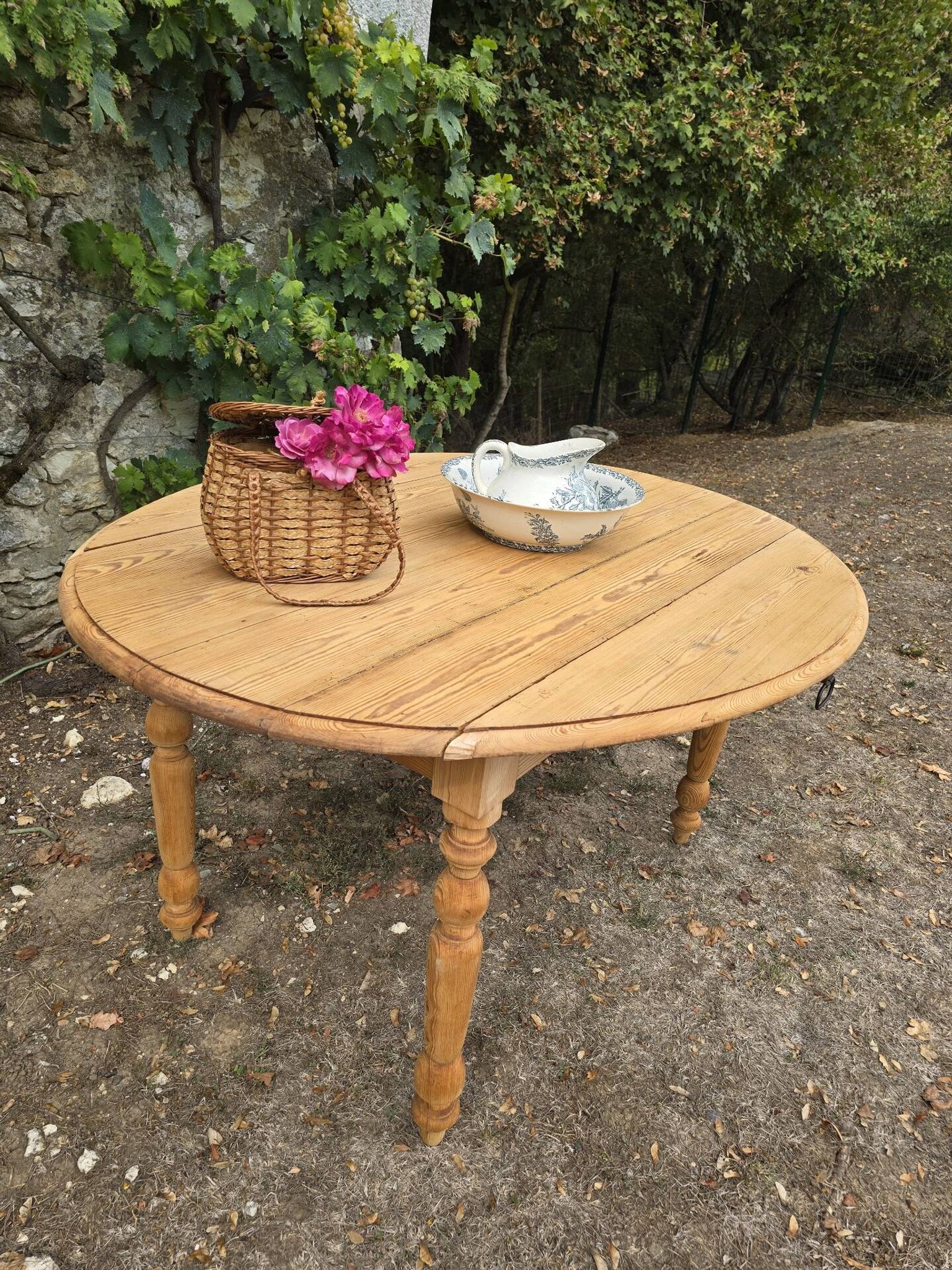 Folding drop-leaf table made of raw solid wood.