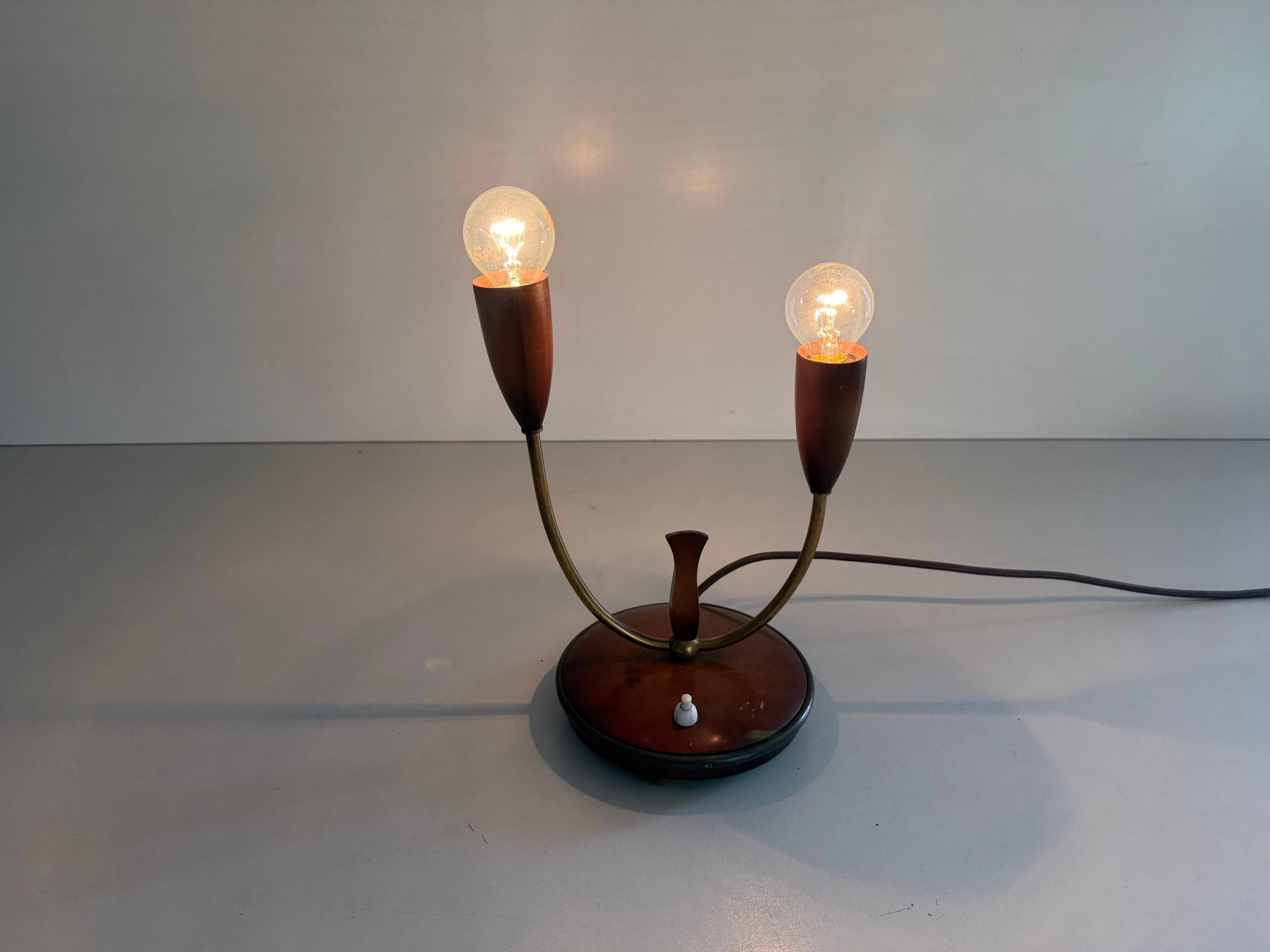 Simple double-headed table lamp in wood and brass, 1960s, Germany.