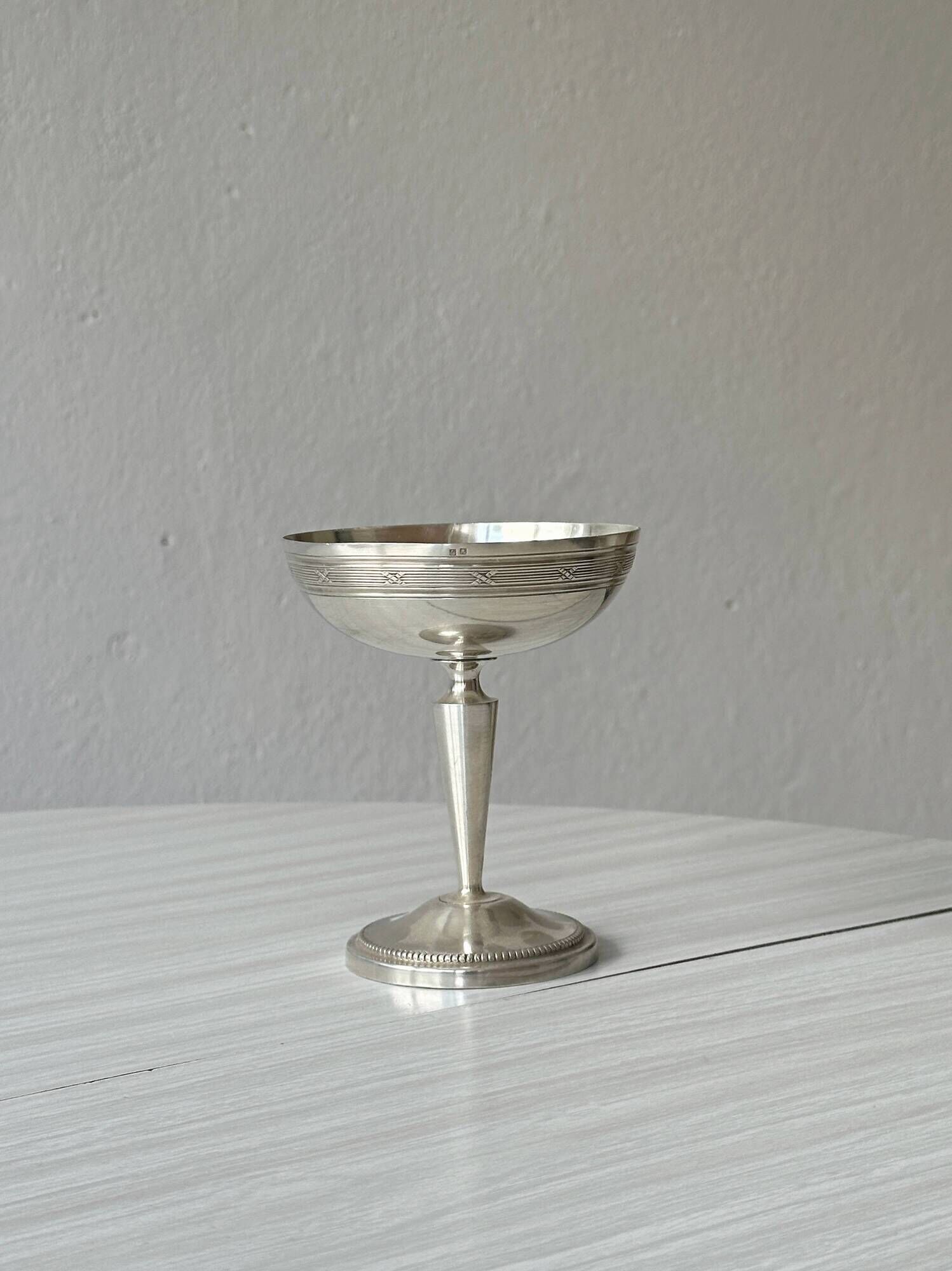 Silver-plated metal stand.
