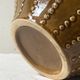 Pyriform vase in glazed ochre ceramic and beads.