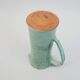 Large green ceramic pitcher with leopard enamel