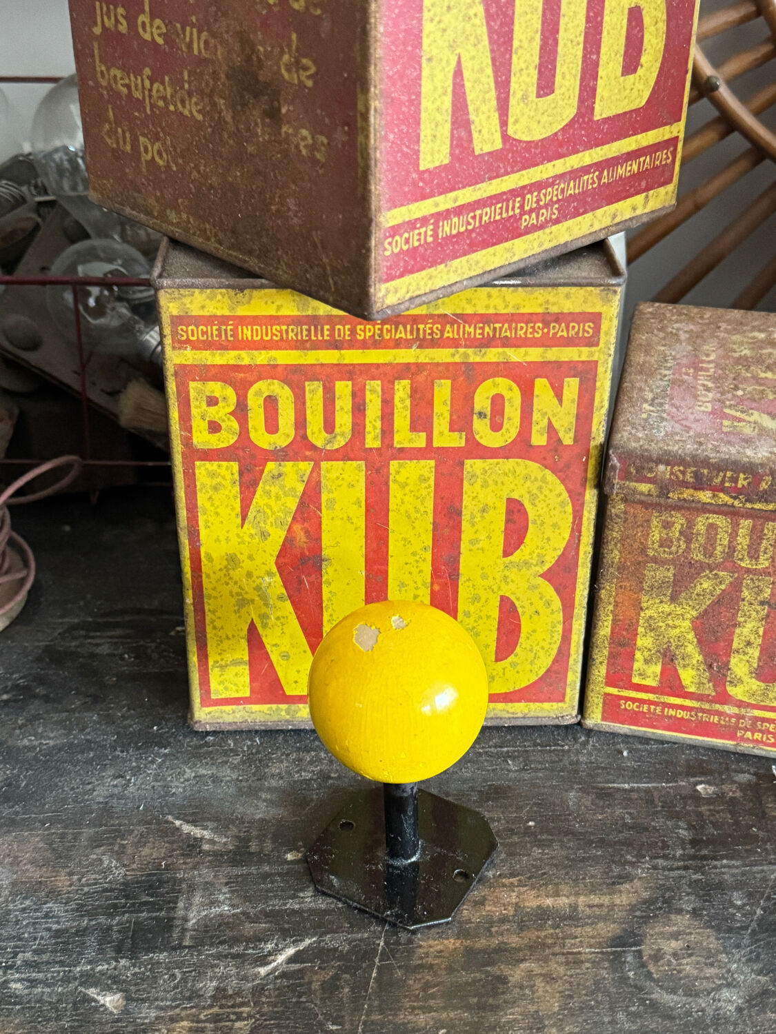 Vintage yellow wooden wall-mounted ball coat hook.