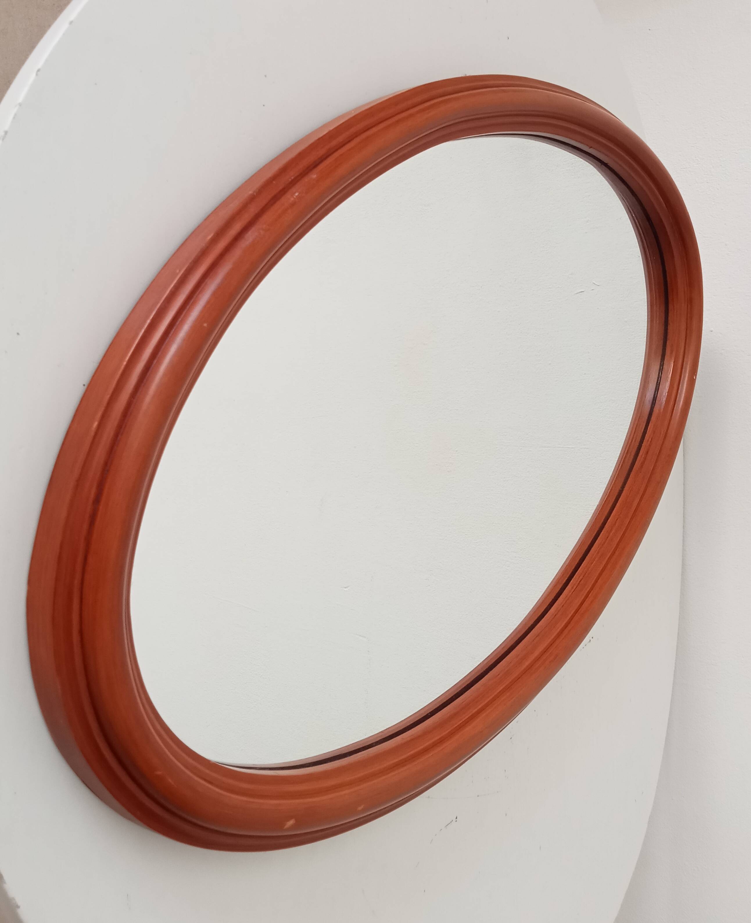 Vintage oval wooden mirror "caramel" from the 1960s.