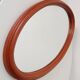 Vintage oval wooden mirror "caramel" from the 1960s.