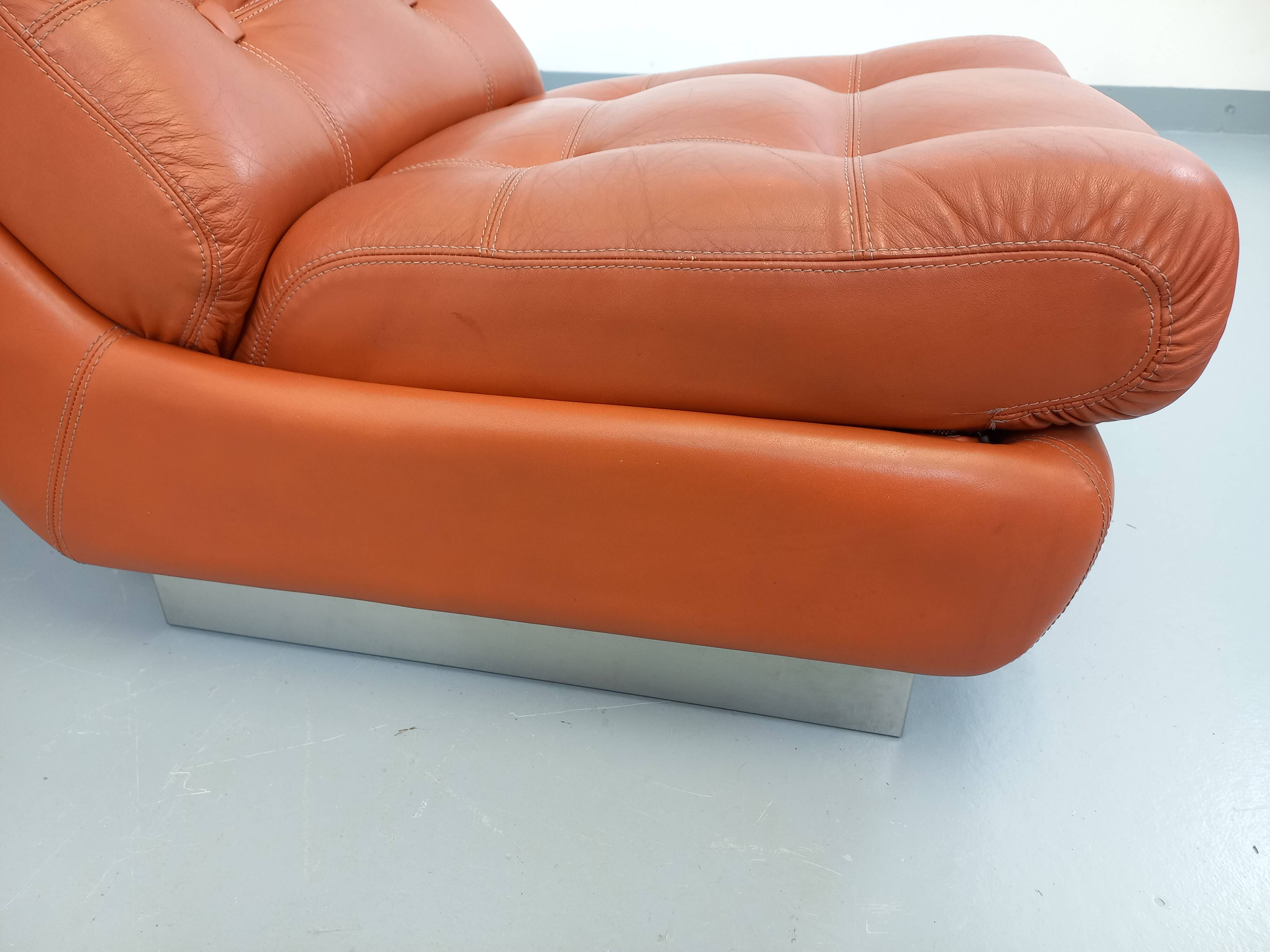 Vintage Roche Bobois armchair in chrome and terracotta leather.