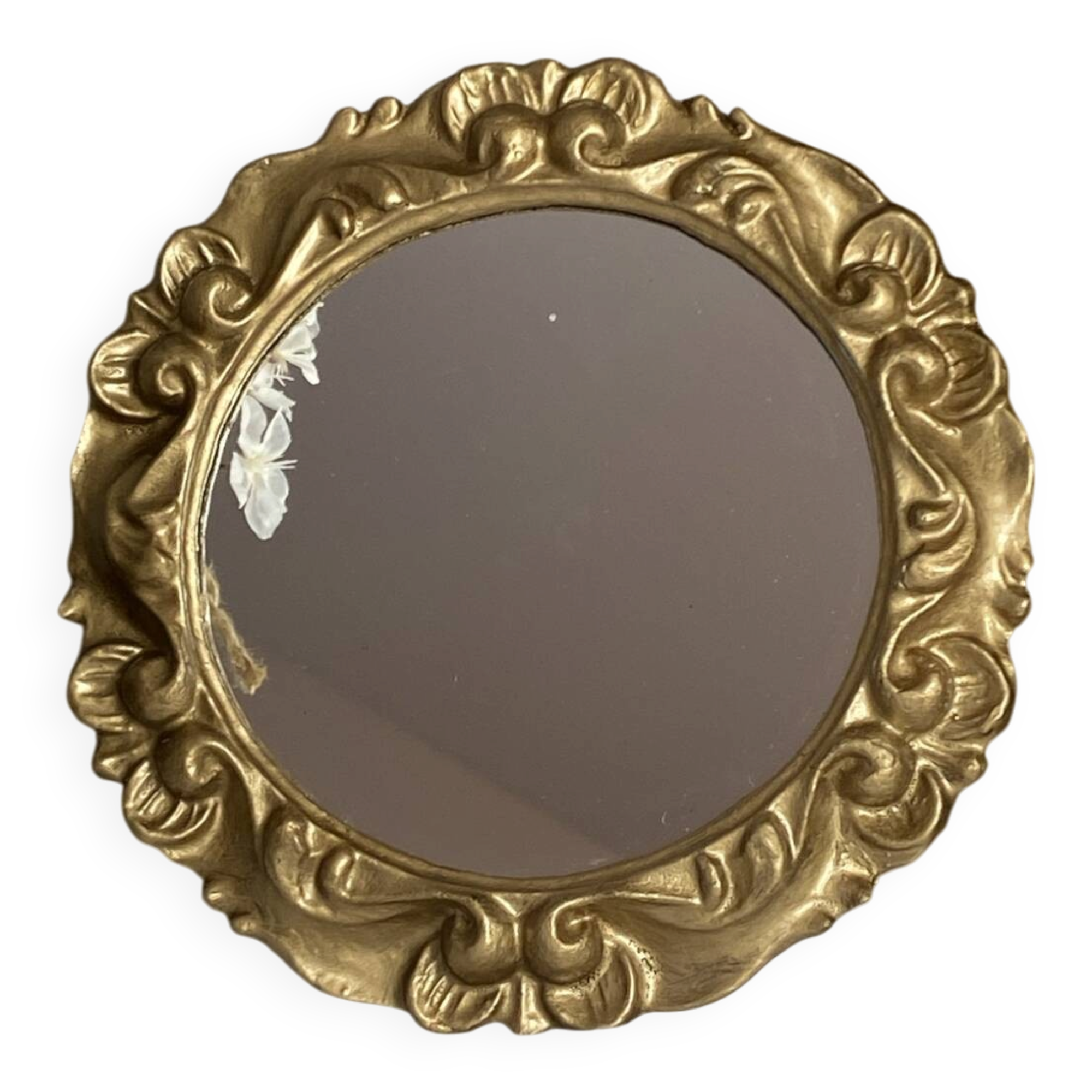 Round wooden mirror in golden colour.