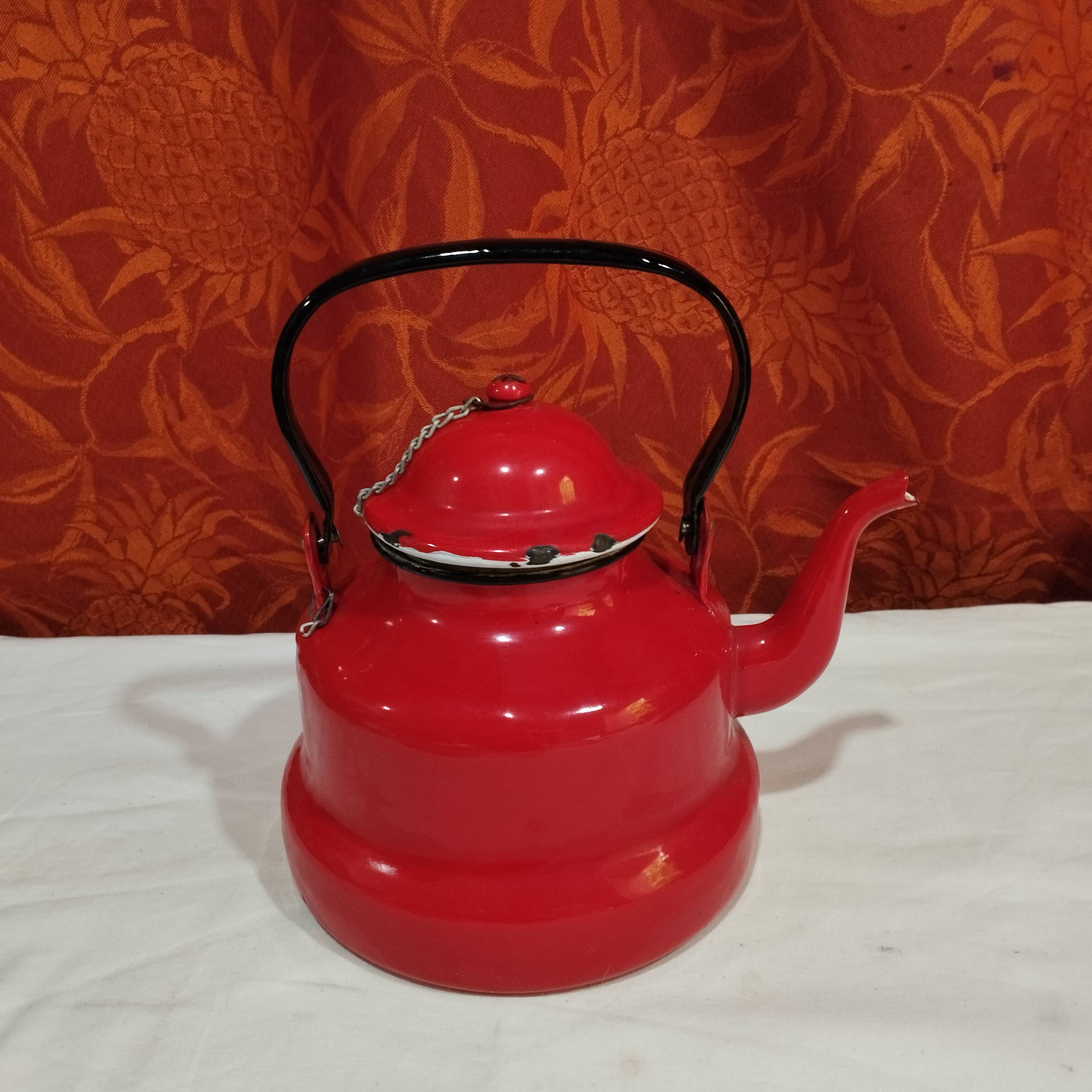 red enamelled sheet metal kettle