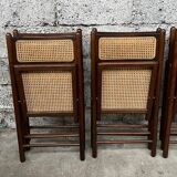 Serie de 8 chaises pliantes vintage en bois et cannage 1960