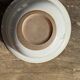 Small thick stoneware bowl with a stylised flower pattern in white on the outside, b