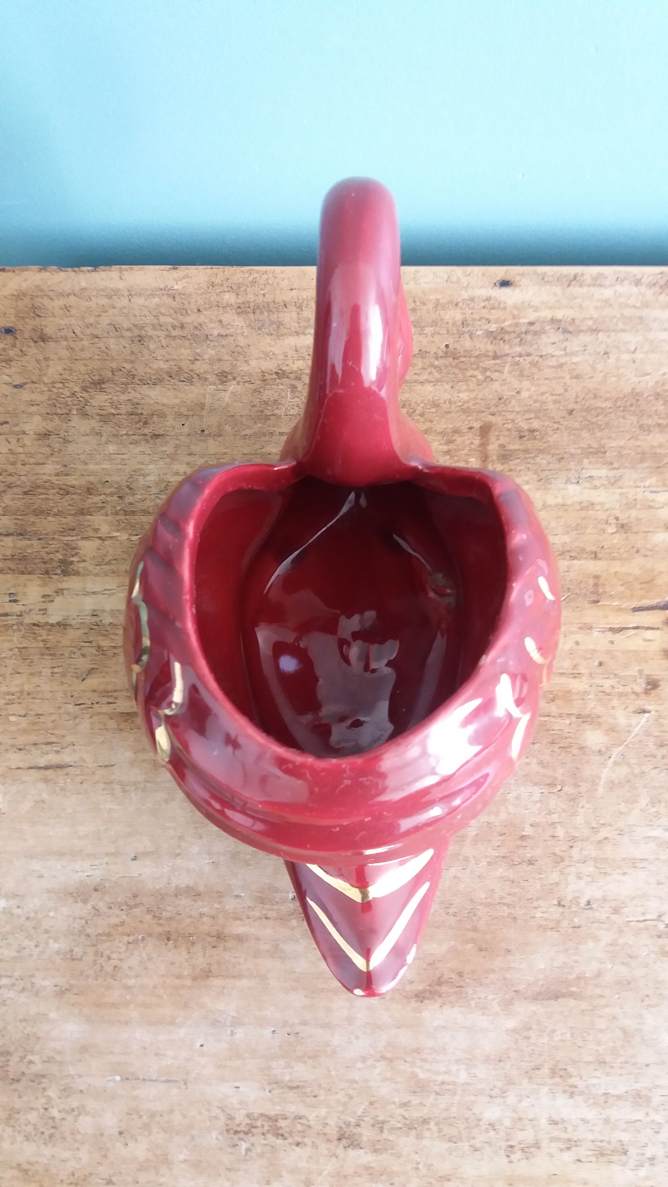 Poet Laval swan hides zoomorphic pot in burgundy ceramic.