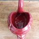 Poet Laval swan hides zoomorphic pot in burgundy ceramic.