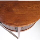 Old mahogany half-moon table with side shutters.