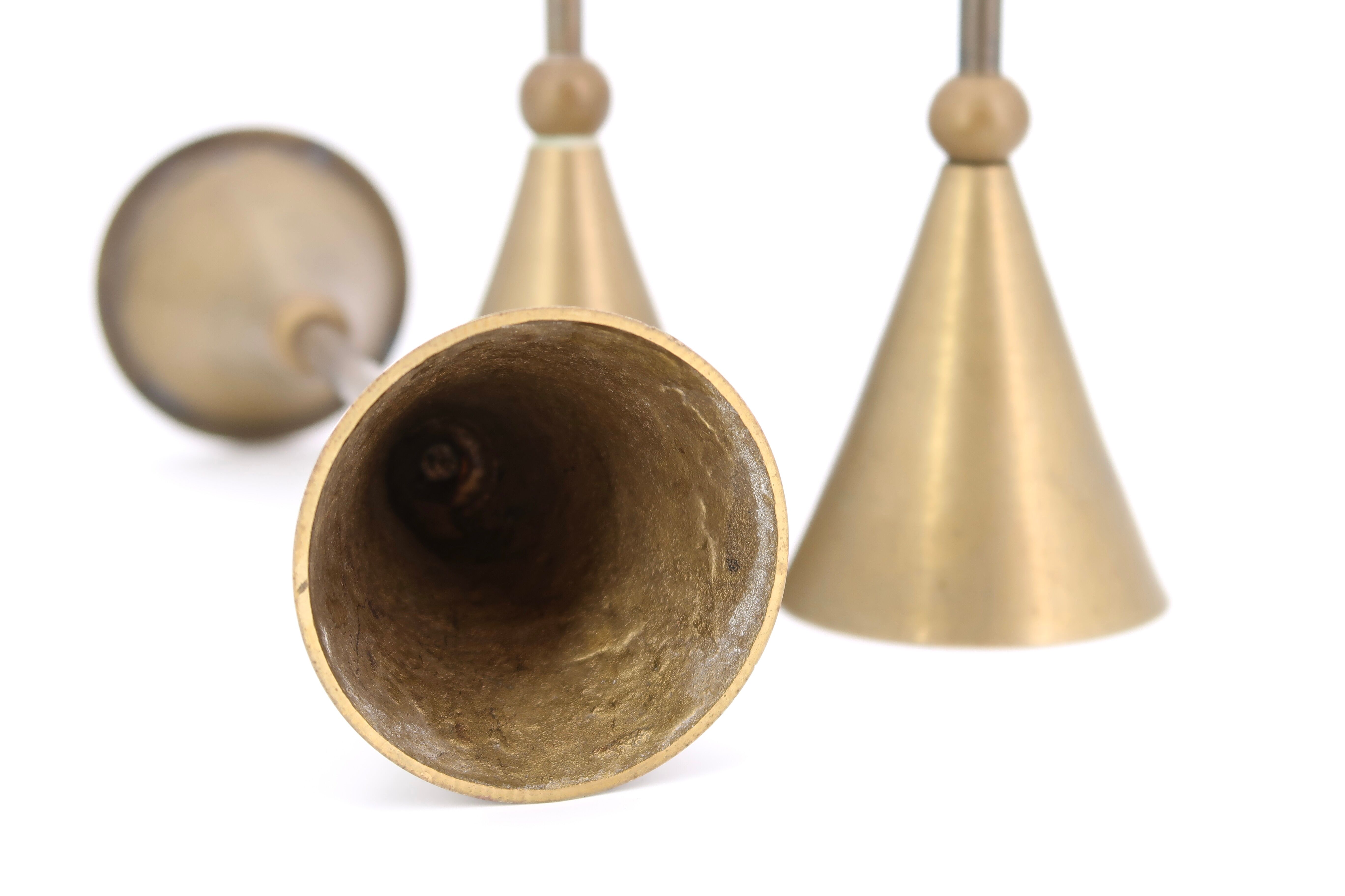 Trio of brass candlesticks by Christian de Beaumont