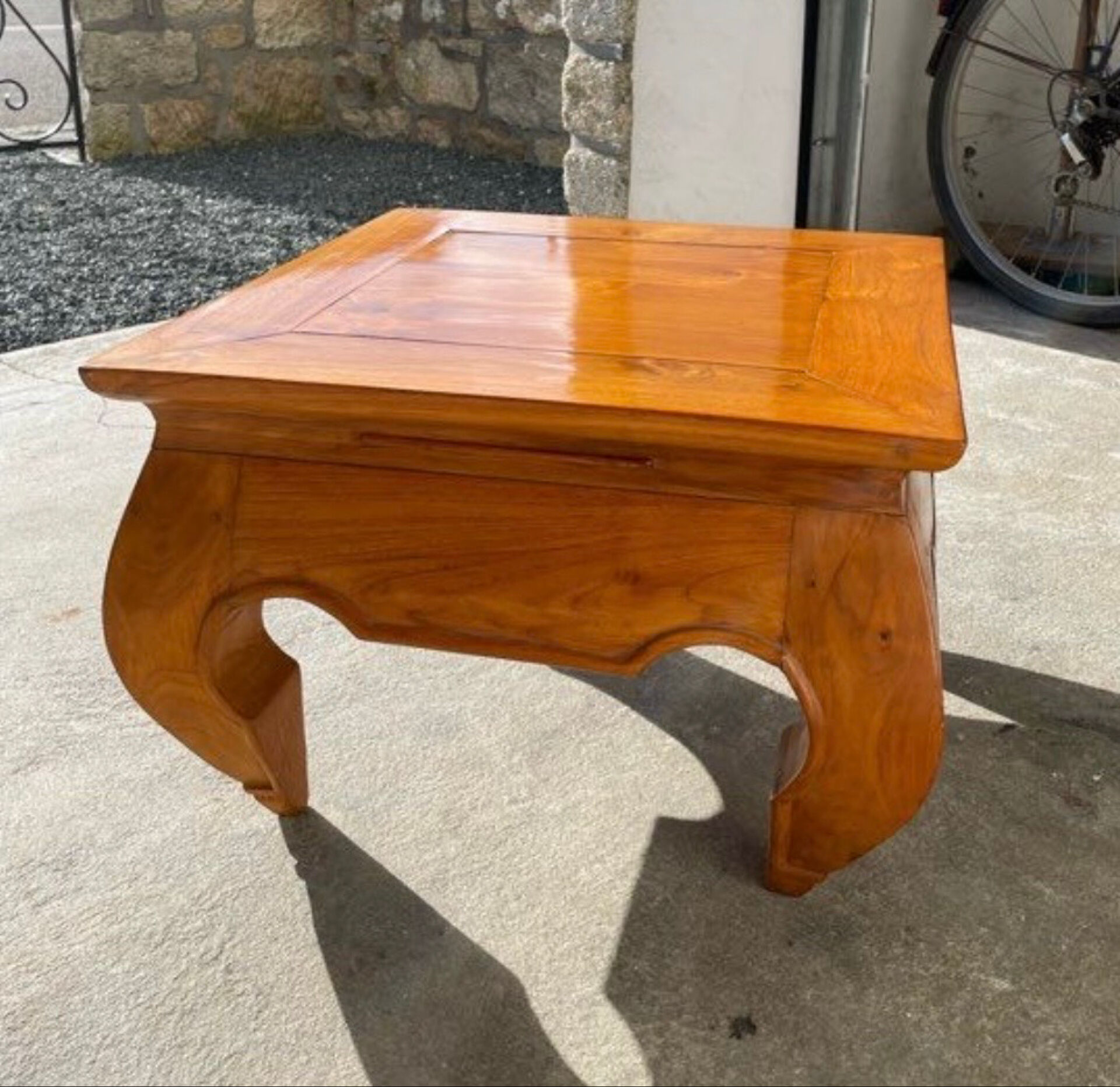 Small solid teak coffee table in opium style.