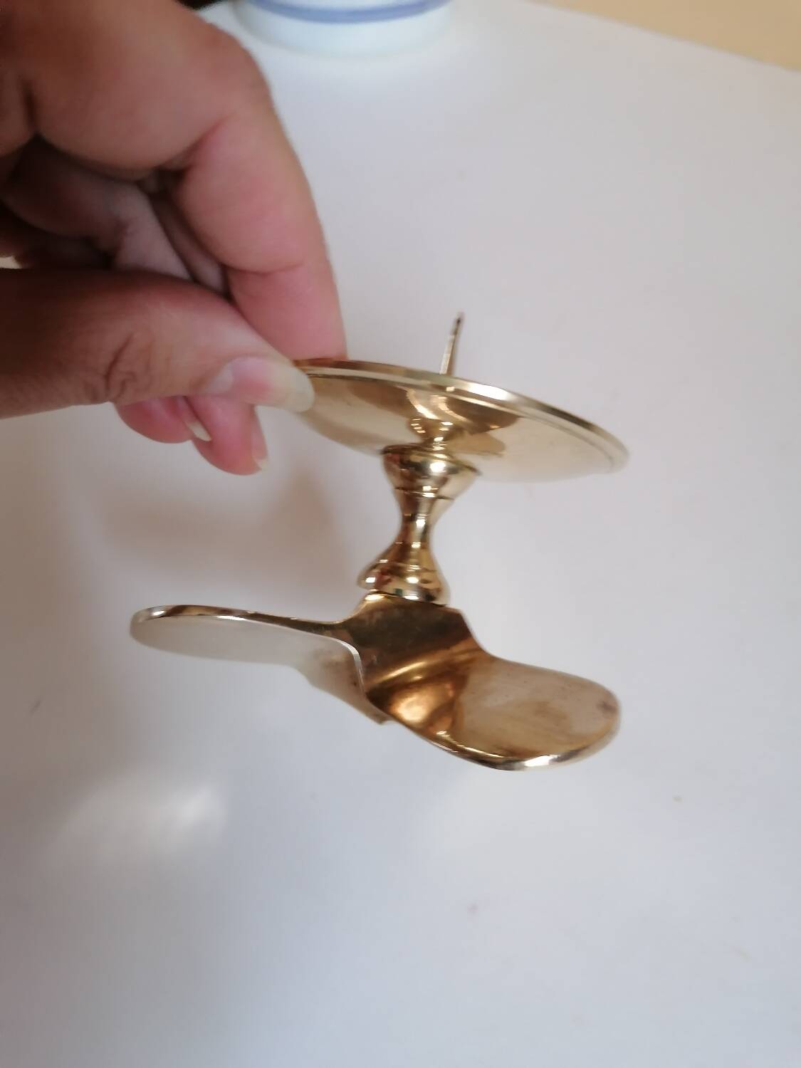 Two brass aviation propeller candle holders