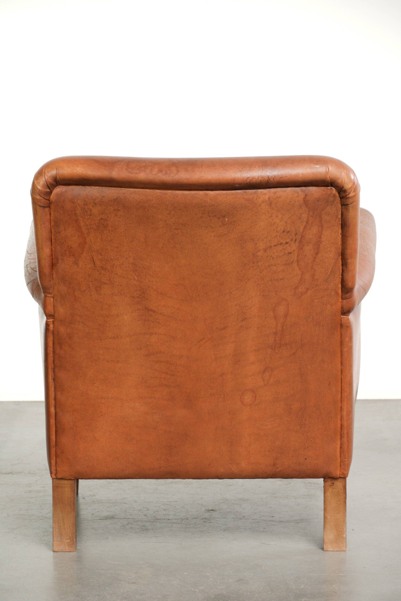 Sturdy vintage sheepskin armchair with a beautiful cognac colour